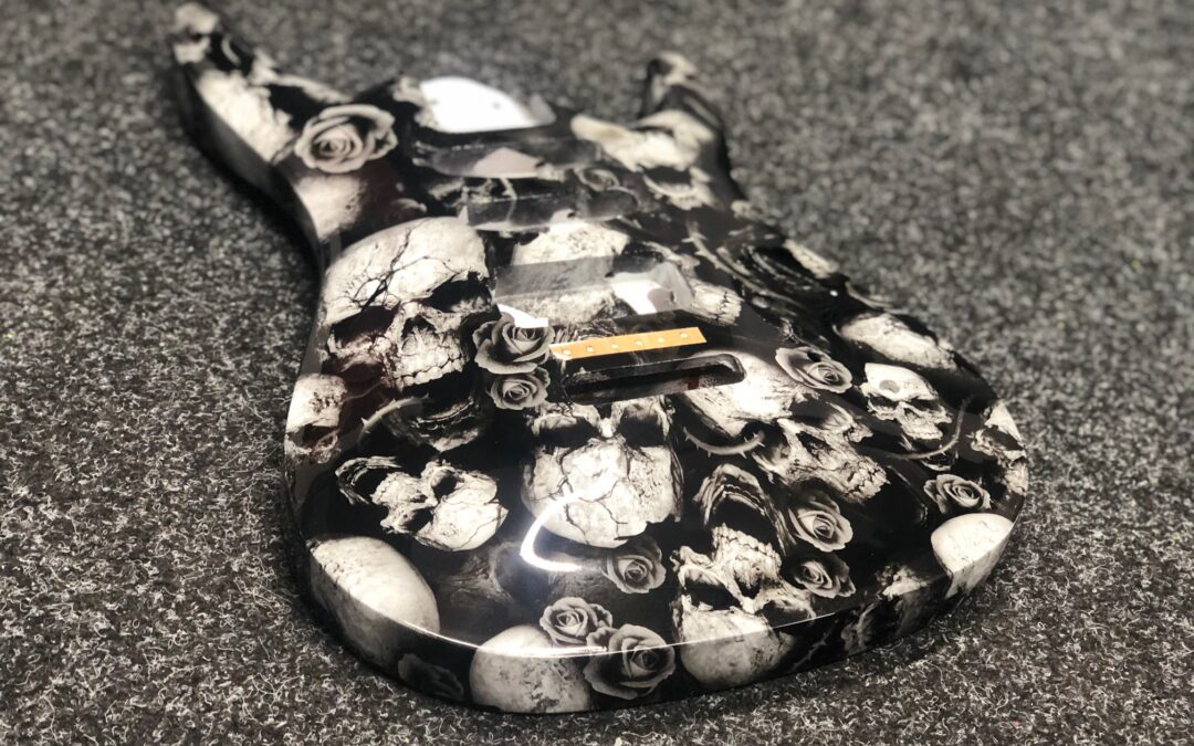 Guitar body and neck hydro dipped in white skulls and roses