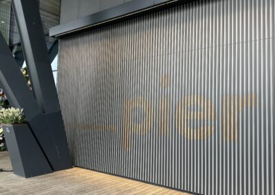 Pier lettering in wood grain slats on the Fulham Pier feature wall