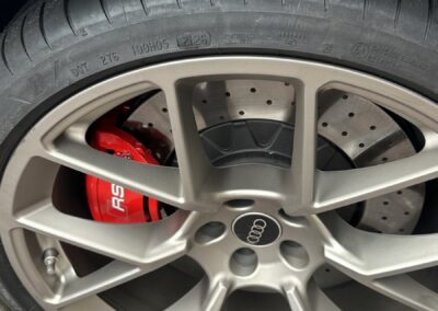 Audi RS5 Hybrid red painted brake caliper and cross-drilled brake disc