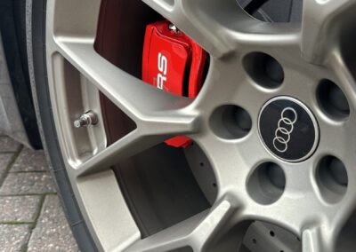 Audi RS5 Hybrid rS logo detail on a red painted brake caliper