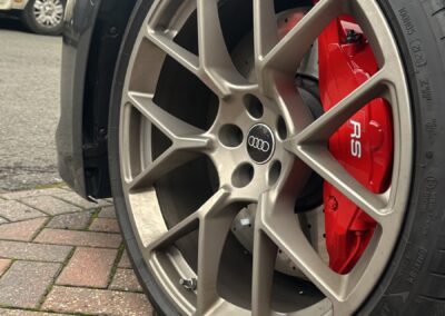 Audi RS5 Hybrid red painted brake caliper behind the front wheel