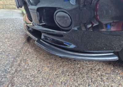 Side view of a carbon fibre hydro dipped BMW E46 front splitter