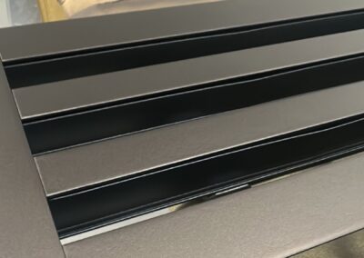 Dark brass air vent grilles in the spray booth