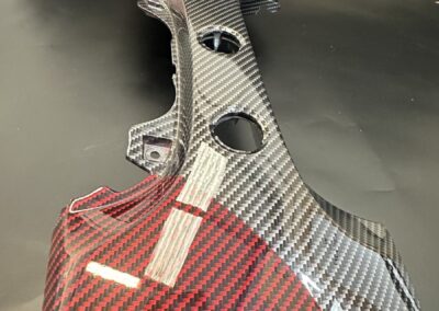 End detail of a red and black carbon Fiat 500 dash trim