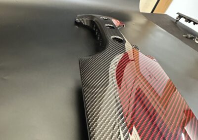 Side view of a red and black carbon Fiat 500 dash trim