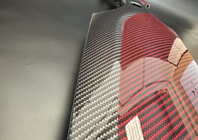Red and black carbon weave detail on a Fiat 500 dash trim