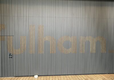 Fulham Pier feature wall with wood grain lettering