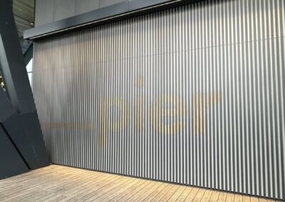 Fulham Pier signage wall beneath a slatted timber ceiling