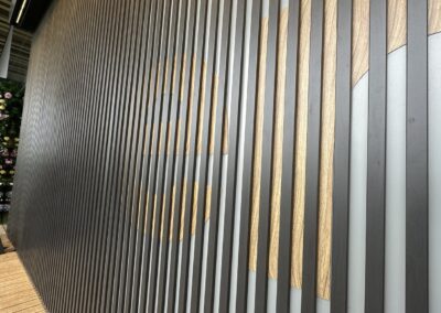 Angled detail of wood grain signage slats at Fulham Pier