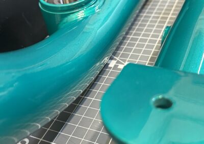 Metallic teal frame arm and bearing housing detail