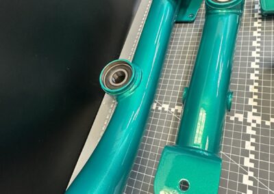 Metallic teal mobility frame arm with bearings