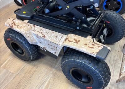 Desert camo powerchair panels beneath the seat lift mechanism