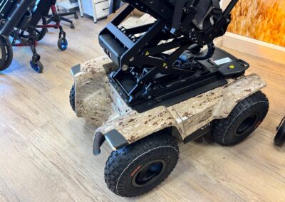 Rear three-quarter view of a desert camo off-road powerchair