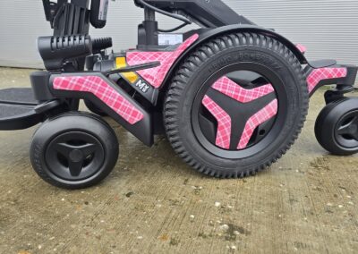 Powerchair Hydro Dipped in a Custom Pink Tartan Film, wheel arch and wheel centre detail