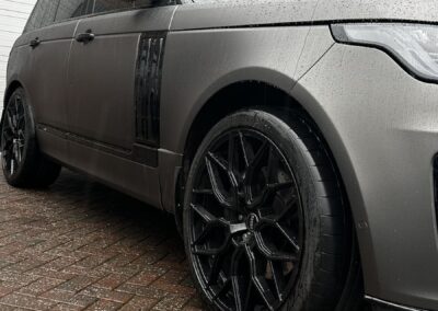 Range Rover Satin Wrap with Gloss Black Painted Exterior and Carbon Interior, side view with gloss black wheel